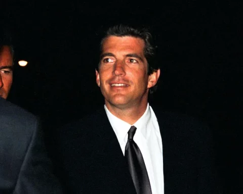 John F. Kennedy Jr. greets guests at a movie premiere.