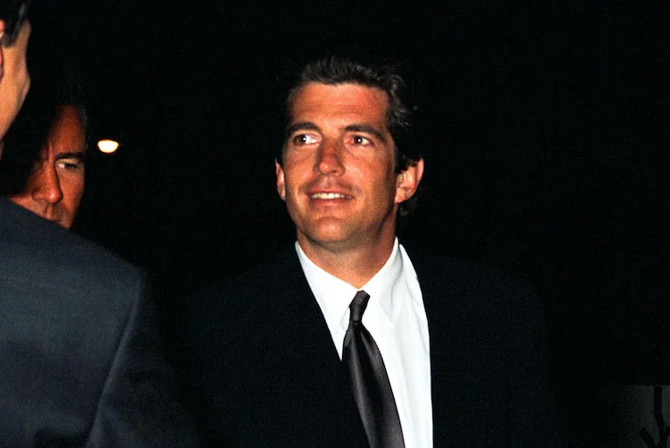 John F. Kennedy Jr. greets guests at a movie premiere.